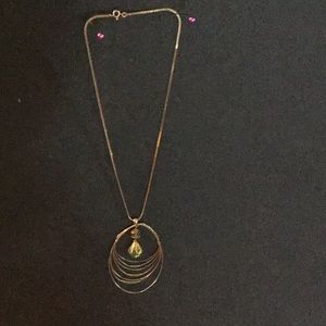 Gold necklace with peridot colored crystal